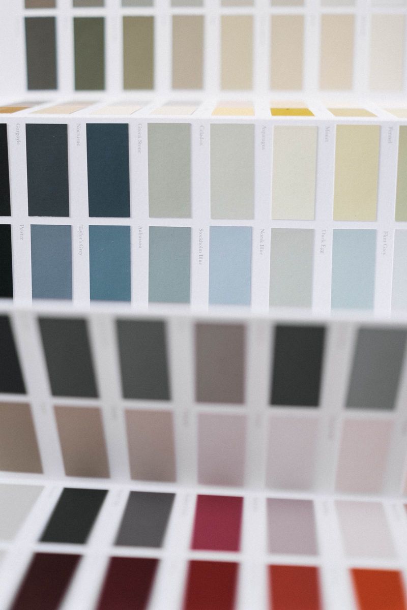 Paint color swatches held against a wall